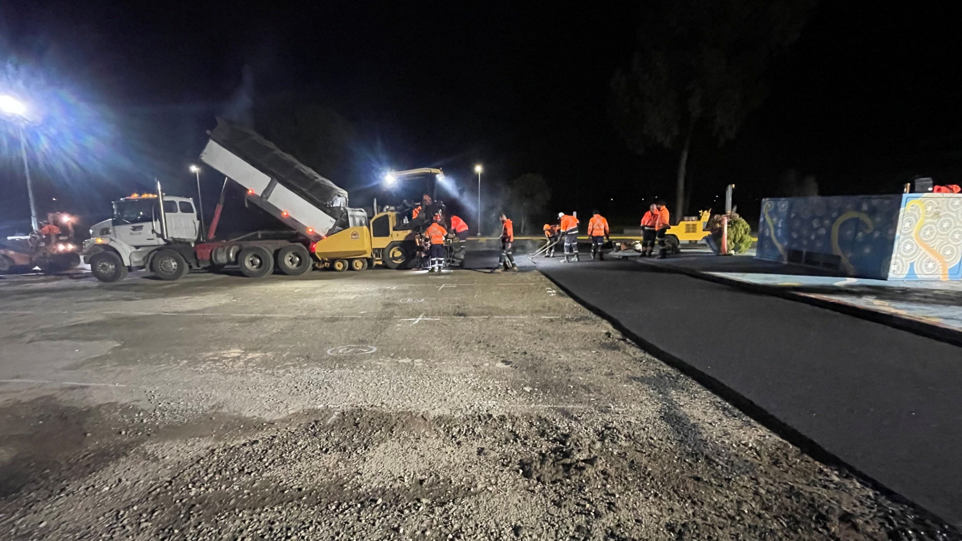 Asphalt paving crew working at night on the MCCC driveway
